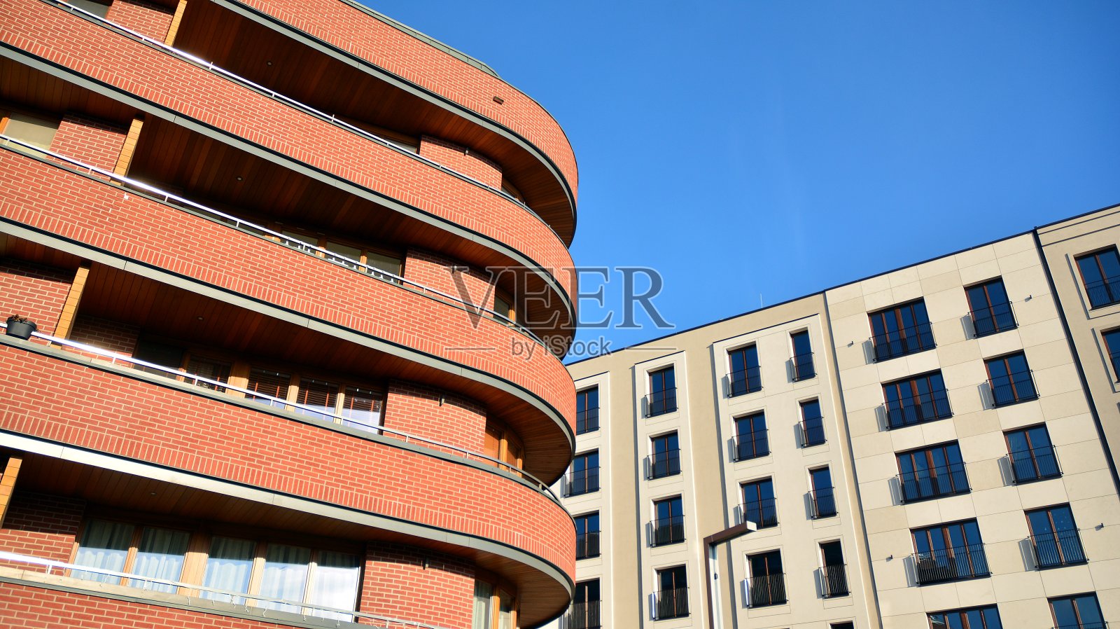 在市中心有对称的现代建筑的公寓和公寓建筑。照片摄影图片