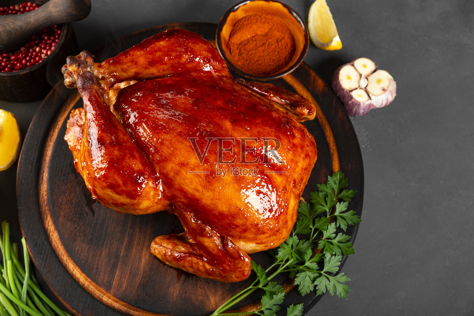 整只辣椒酱烤鸡放在盘子上，圣诞餐桌布置在俯视图上照片摄影图片