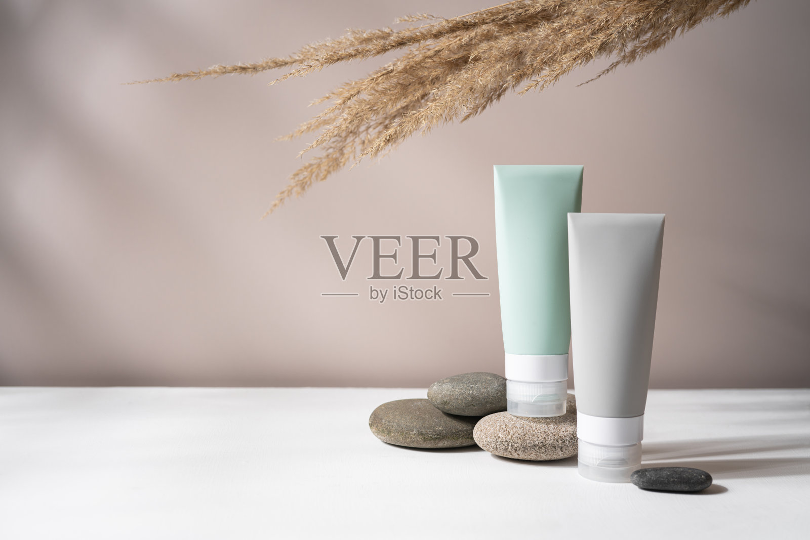 化妆品瓶子在鹅卵石上照片摄影图片