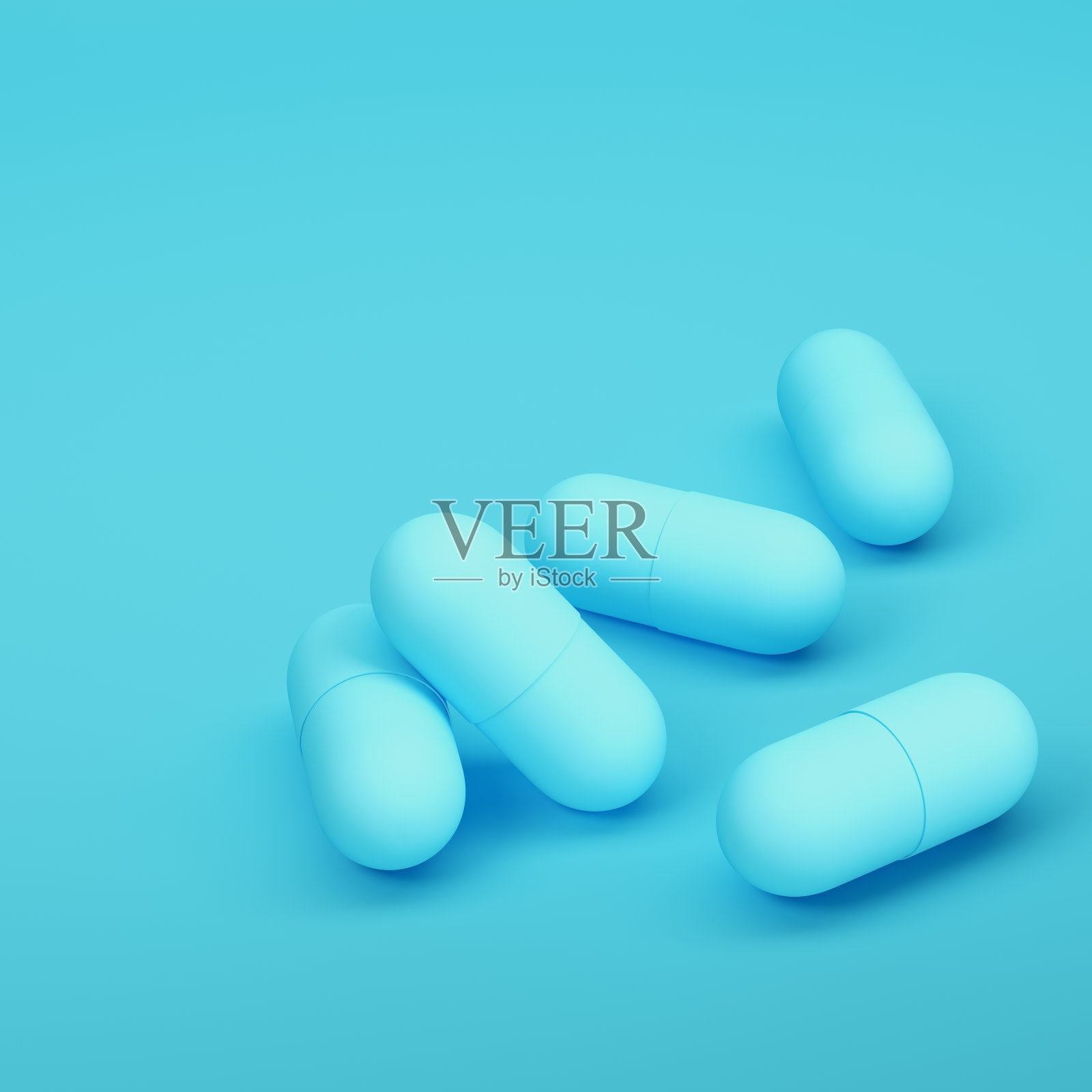 胶囊药丸在明亮的蓝色背景在柔和的颜色照片摄影图片