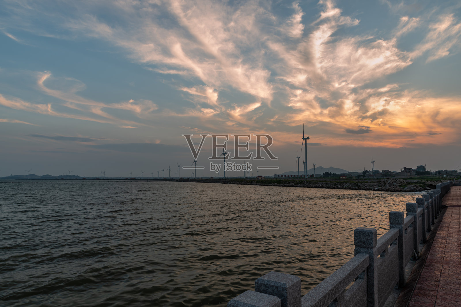 黄昏沙滩上的云朵和风车照片摄影图片