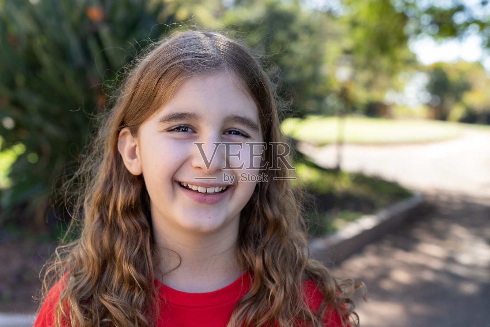 长发男孩微笑着。照片摄影图片