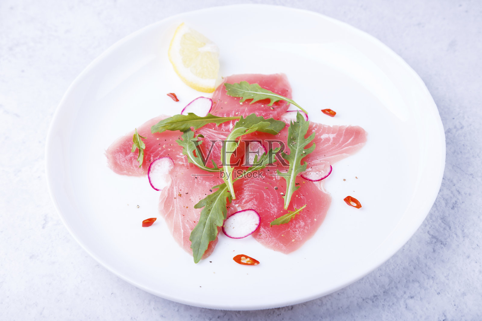 新鲜金枪鱼片配芝麻菜，小萝卜，红辣椒和柠檬。意大利传统冷食。特写,选择照片摄影图片
