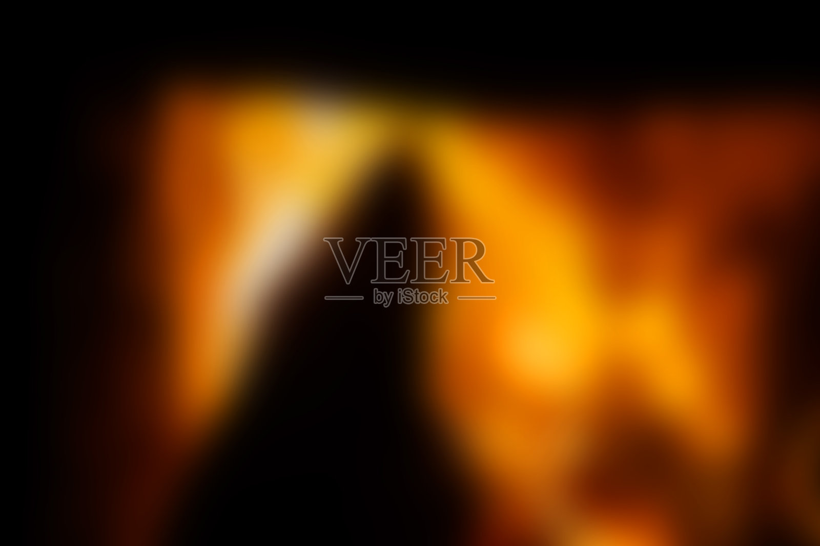 模糊的背景，明亮的橙色和黑色，壁炉照片摄影图片