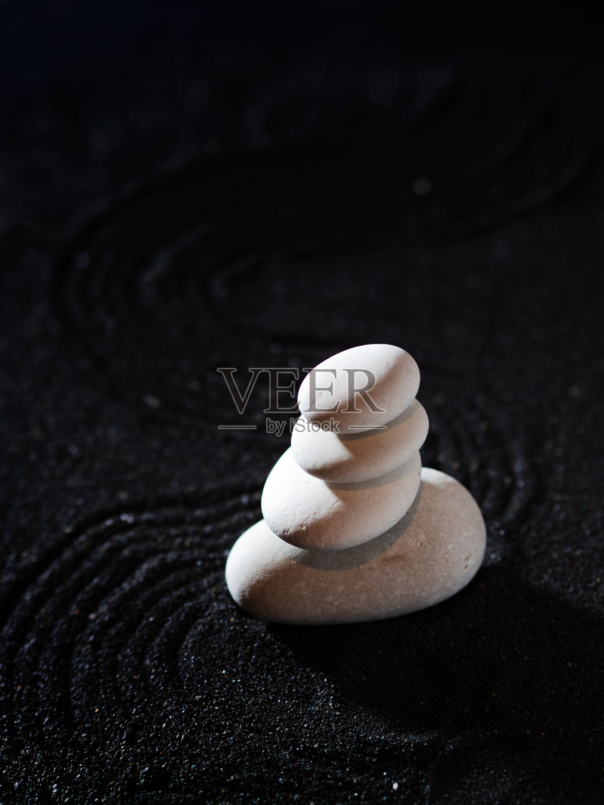 岩石花园，黑色沙滩上的白色鹅卵石，波浪形图案。照片摄影图片