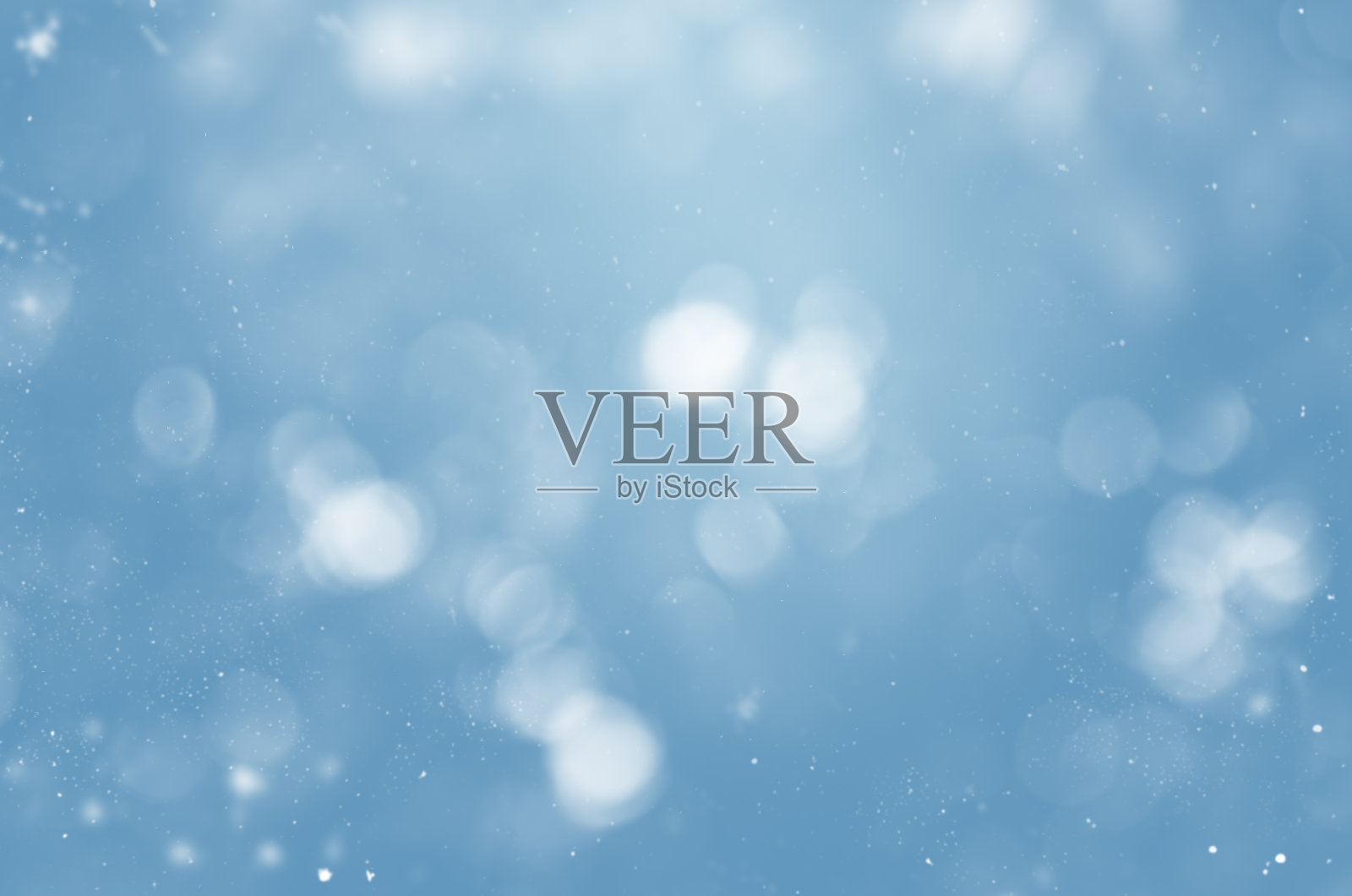 模糊的蓝色背景与雪花和散景照片摄影图片