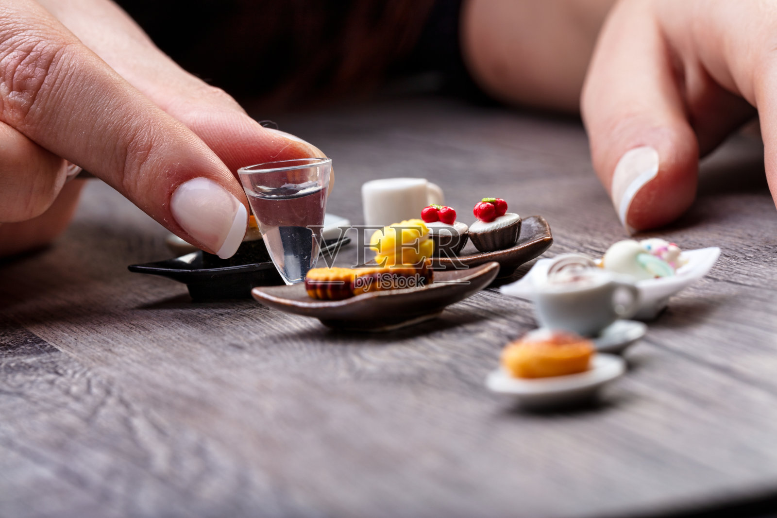 女人的手放在桌上的迷你餐照片摄影图片