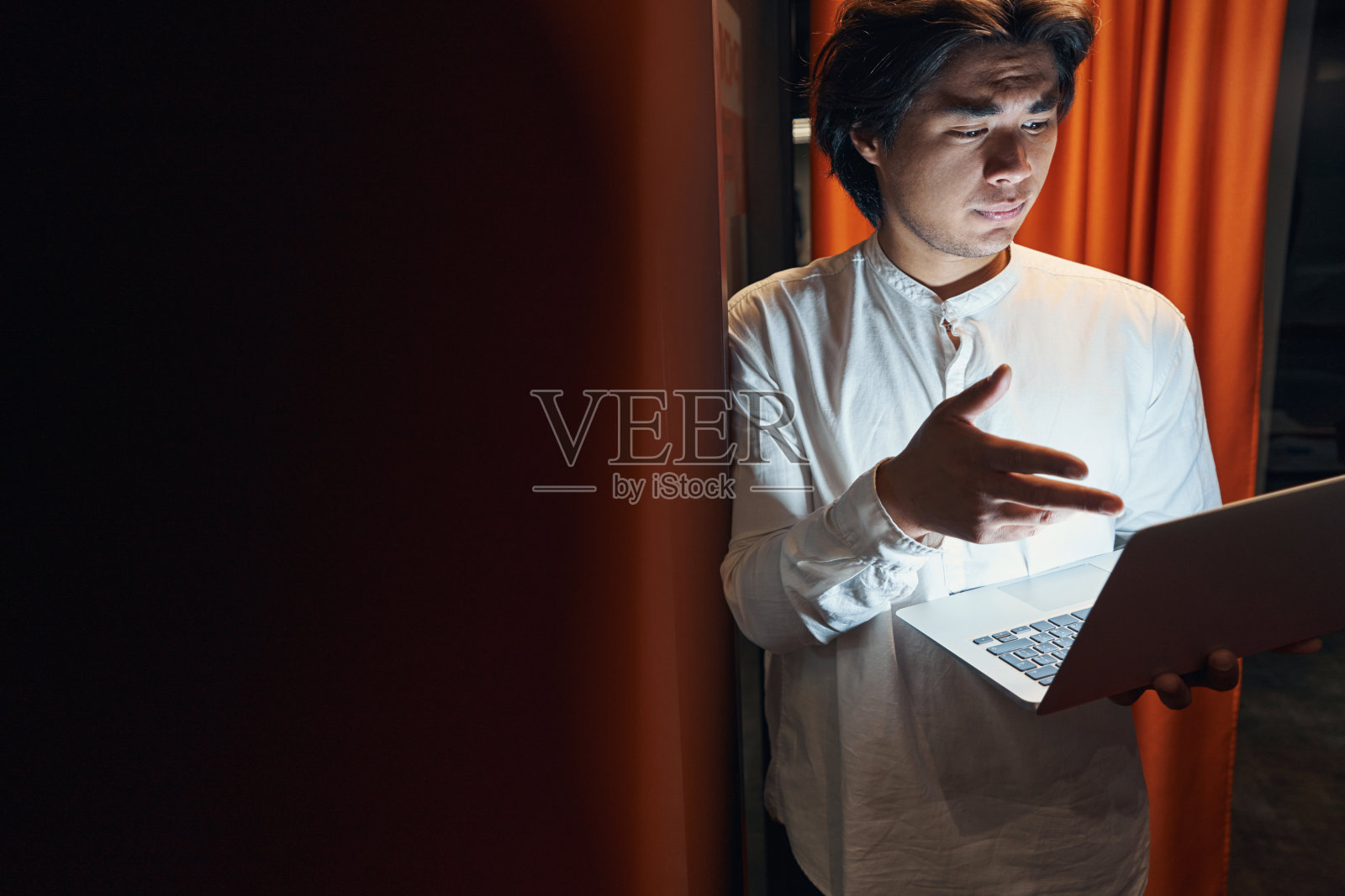 男子将手指放在笔记本电脑屏幕上照片摄影图片