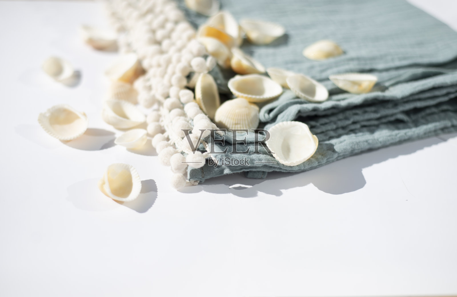 有绒球的薄纱毛巾。贝壳。环保纺织品。照片摄影图片