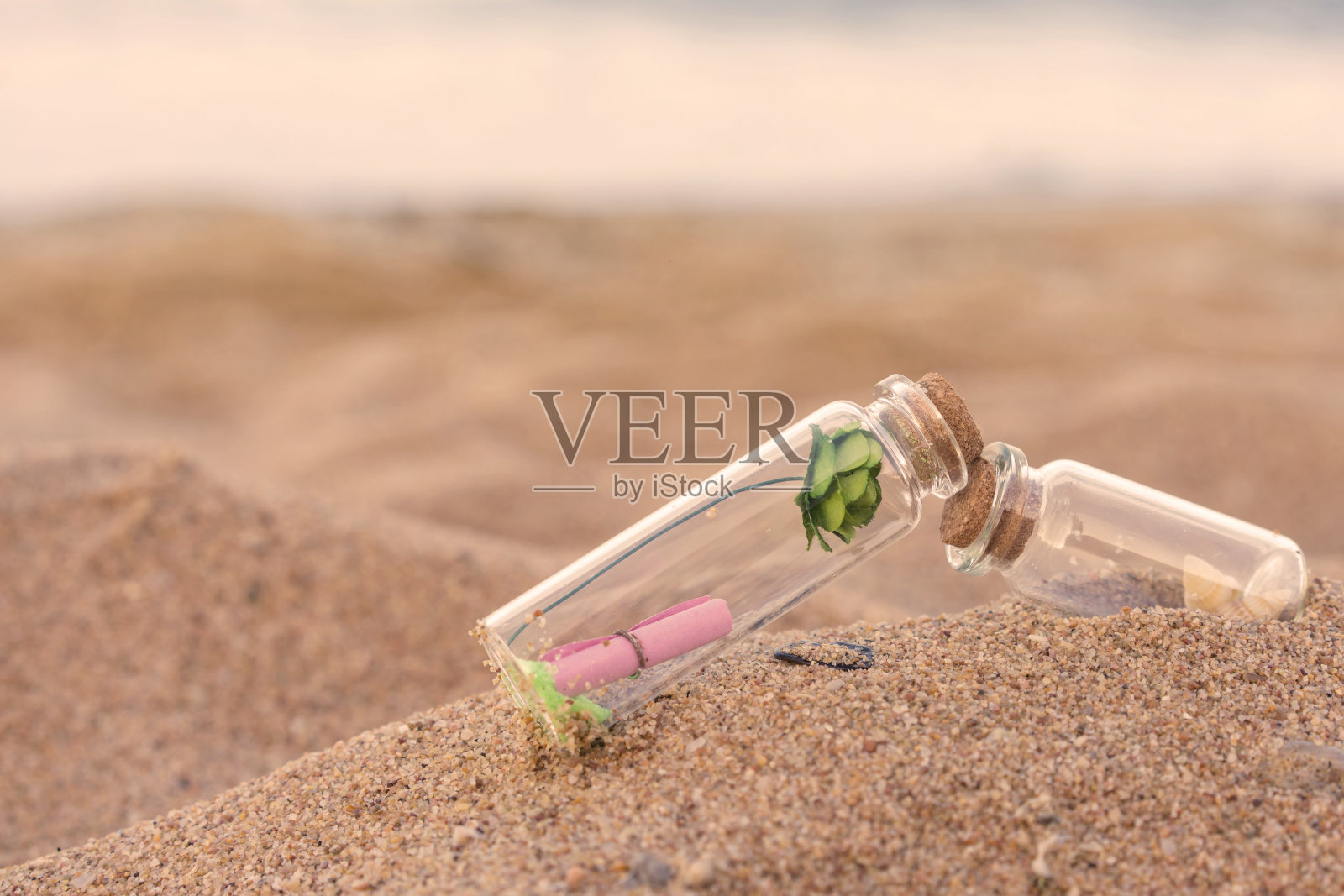 在热带海滩上装在瓶子里的信件照片摄影图片
