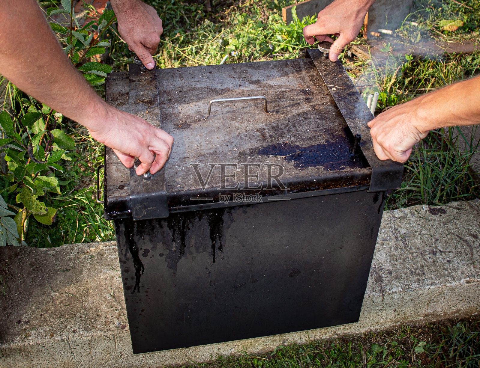 巨大的黑色金属烟熏室和手照片摄影图片