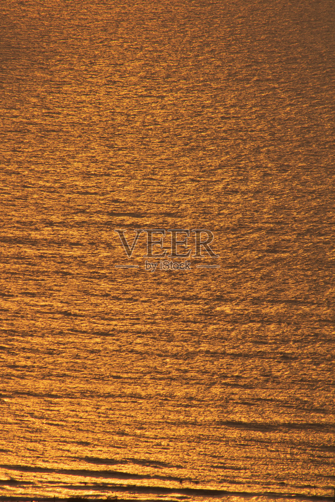 橙色的太阳映在蓝色的海面上照片摄影图片