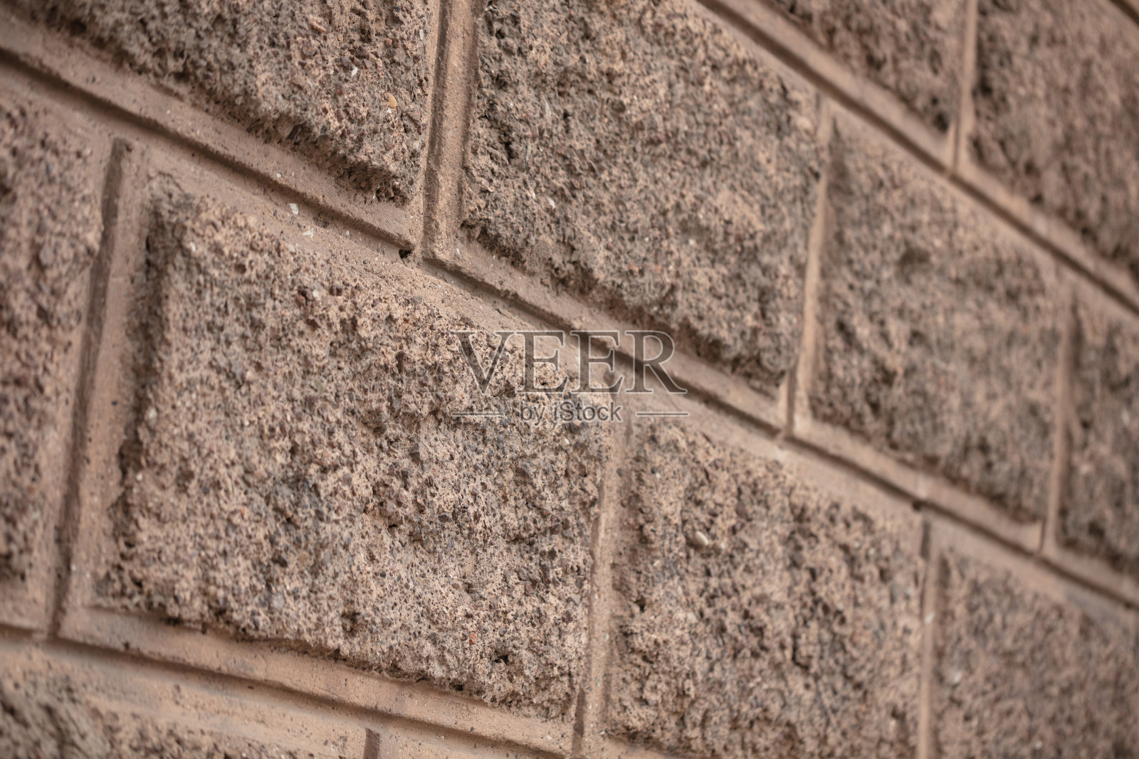 光滑而漂亮的石头和砖砌体。用于建造房屋的石墙的建筑和设计照片摄影图片