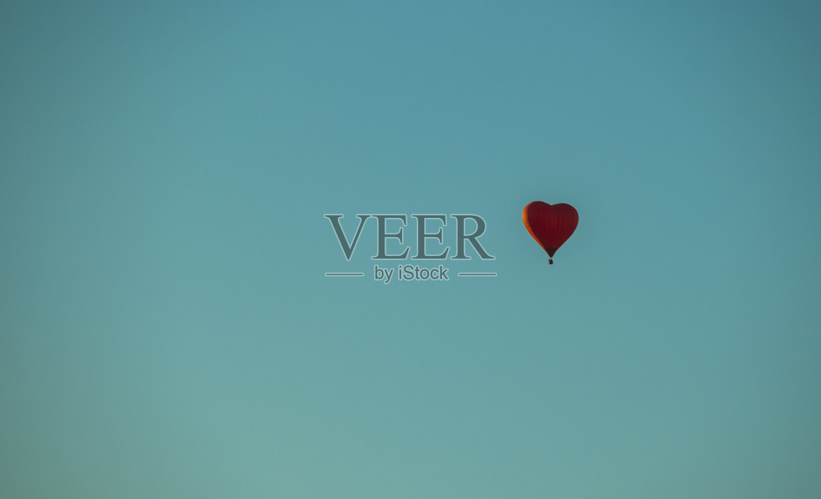 蓝色背景上的红心形状的热气球照片摄影图片