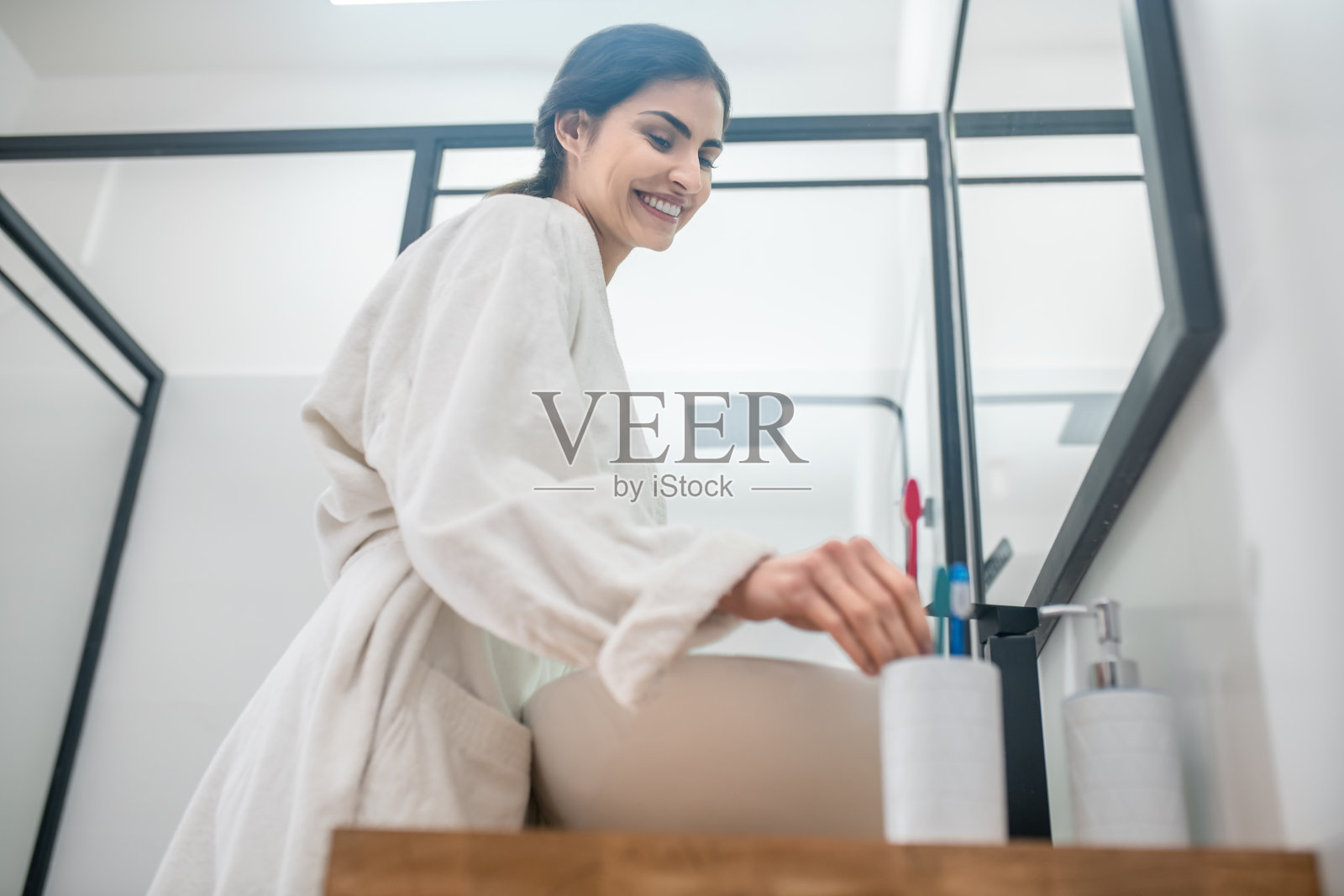 一个穿着白色浴袍的女人在浴室里做早操照片摄影图片