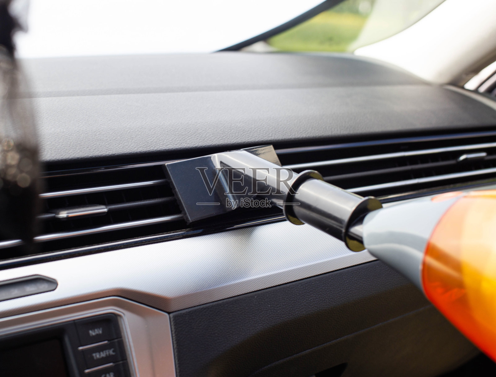 用吸尘器清洗现代汽车内饰，去除背景灰尘和灰尘。设备照片摄影图片