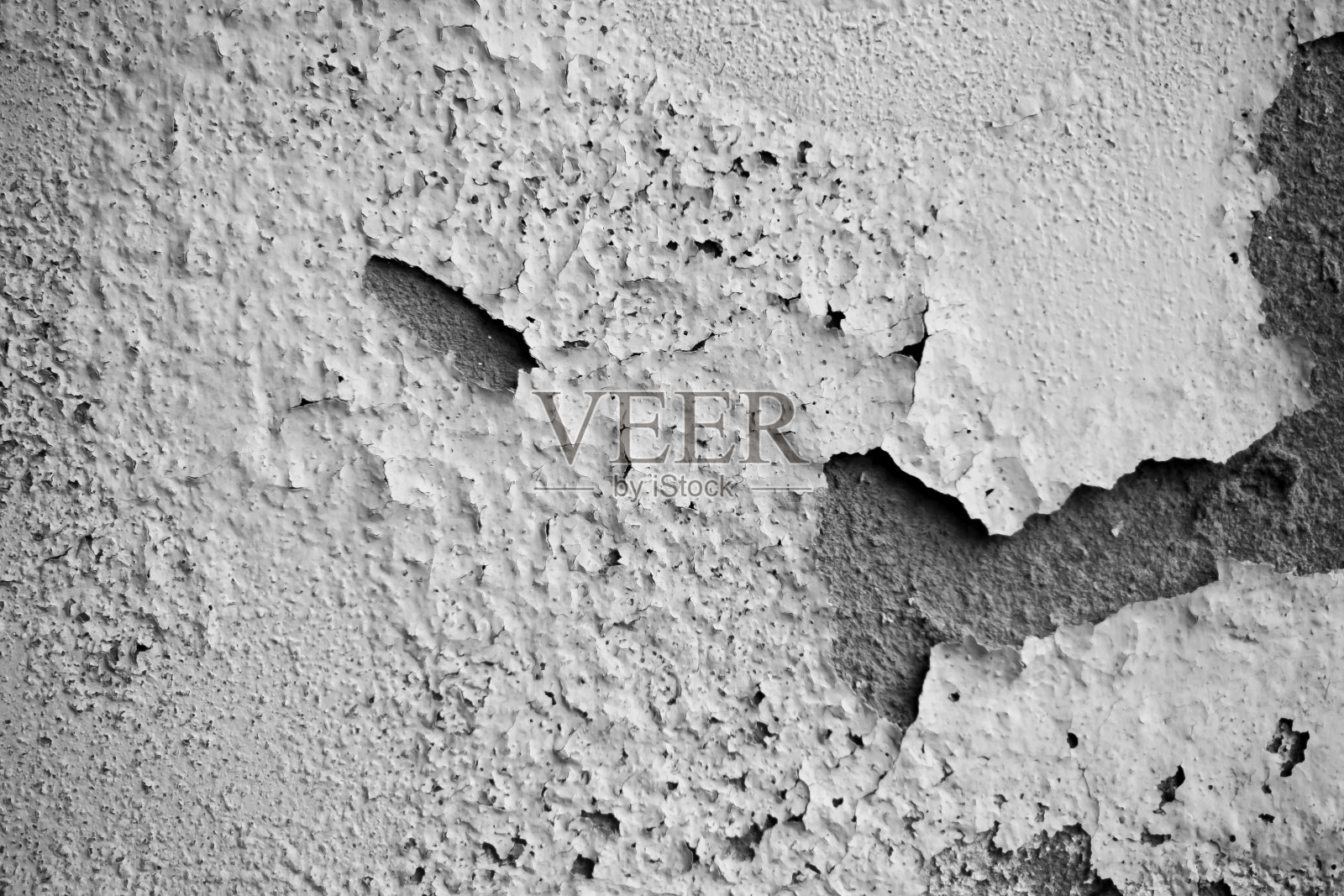 白色潮湿的墙壁显示油漆开裂、开裂或剥落。脆弱的白色墙衬。抽象破裂和膨胀的黑白背景。宏特写视图。照片摄影图片