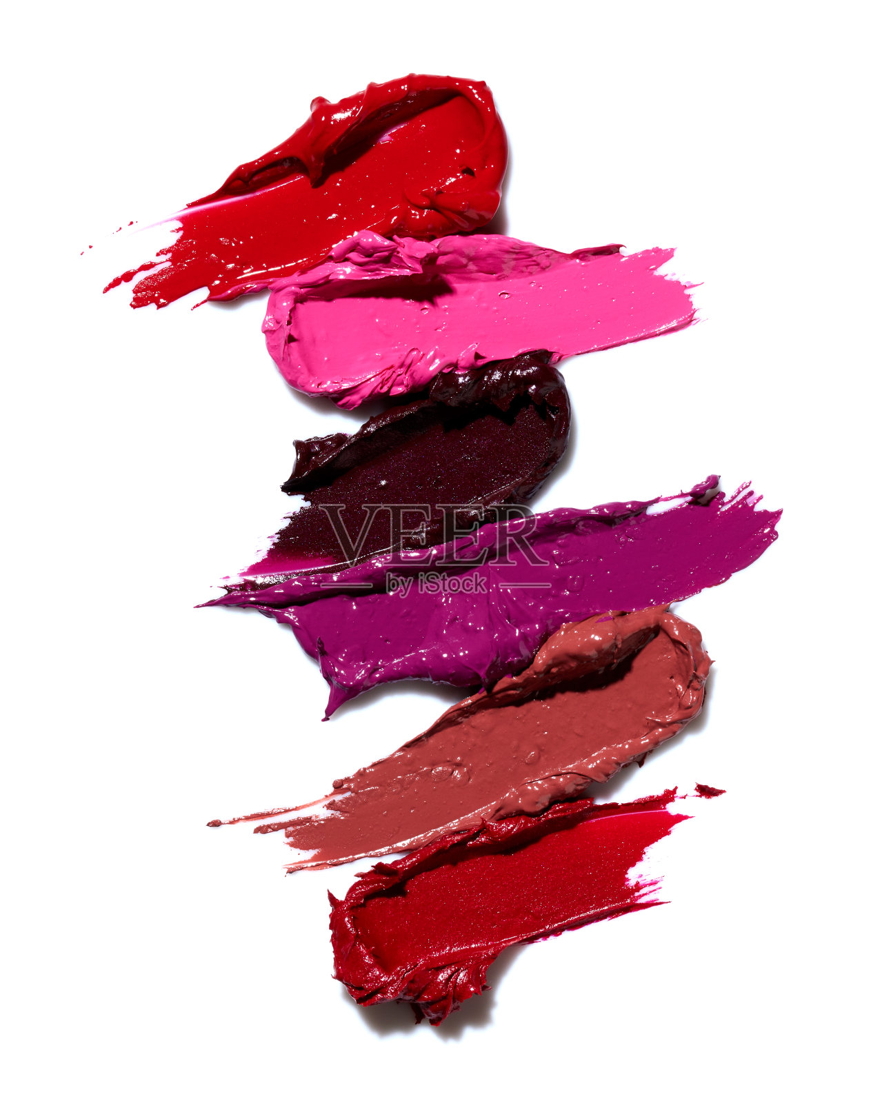 在白色背景上设置不同颜色的口红色块照片摄影图片