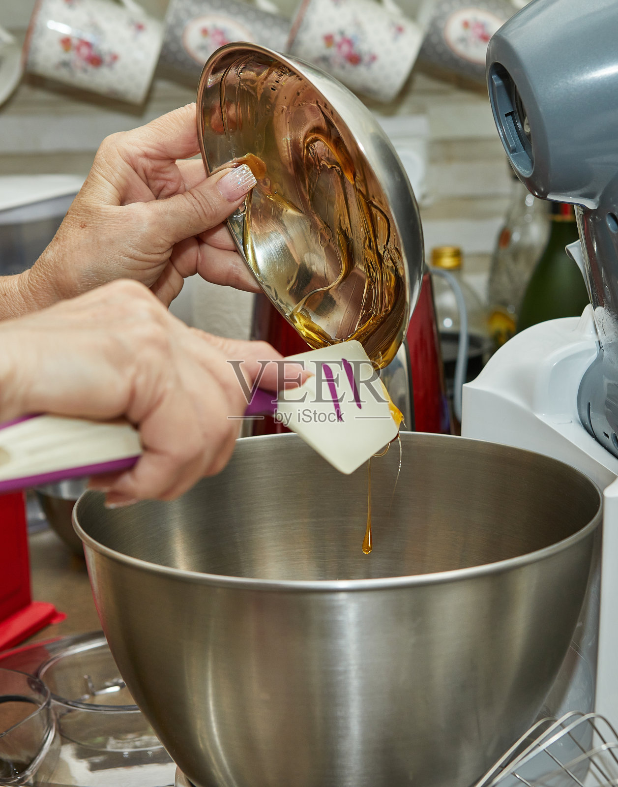 厨师用抹刀将蜂蜜从碗里倒入沙拉。逐步食谱照片摄影图片