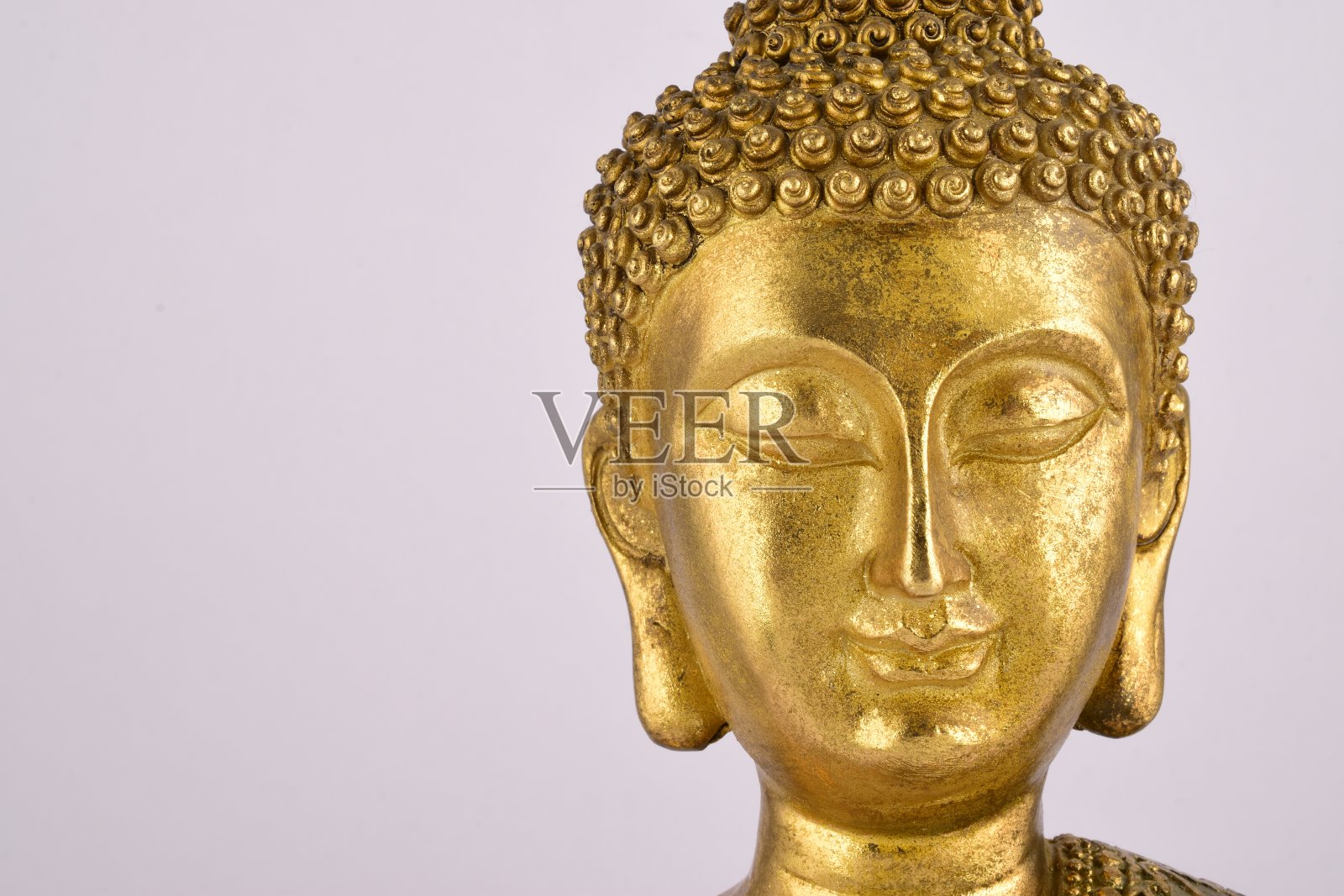 白色背景上的金佛脸照片摄影图片