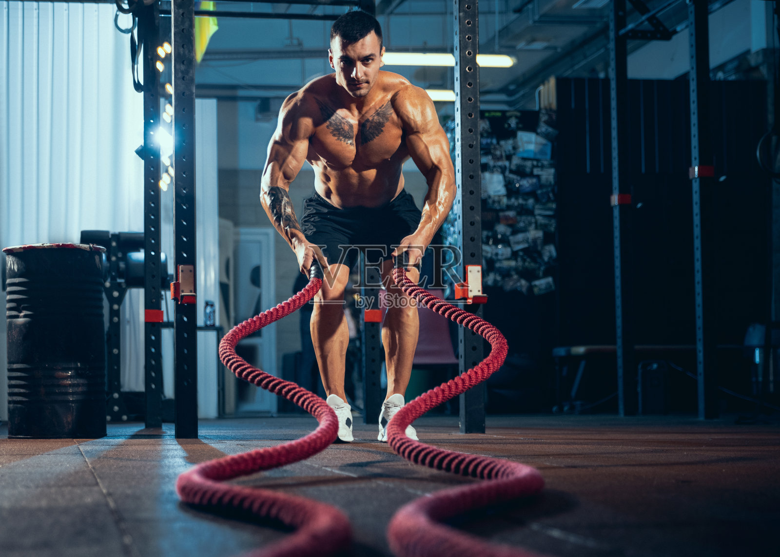 年轻人，肌肉发达的运动员，健美运动员在室内体育馆里独自训练。运动的概念，活动，健康的生活方式照片摄影图片