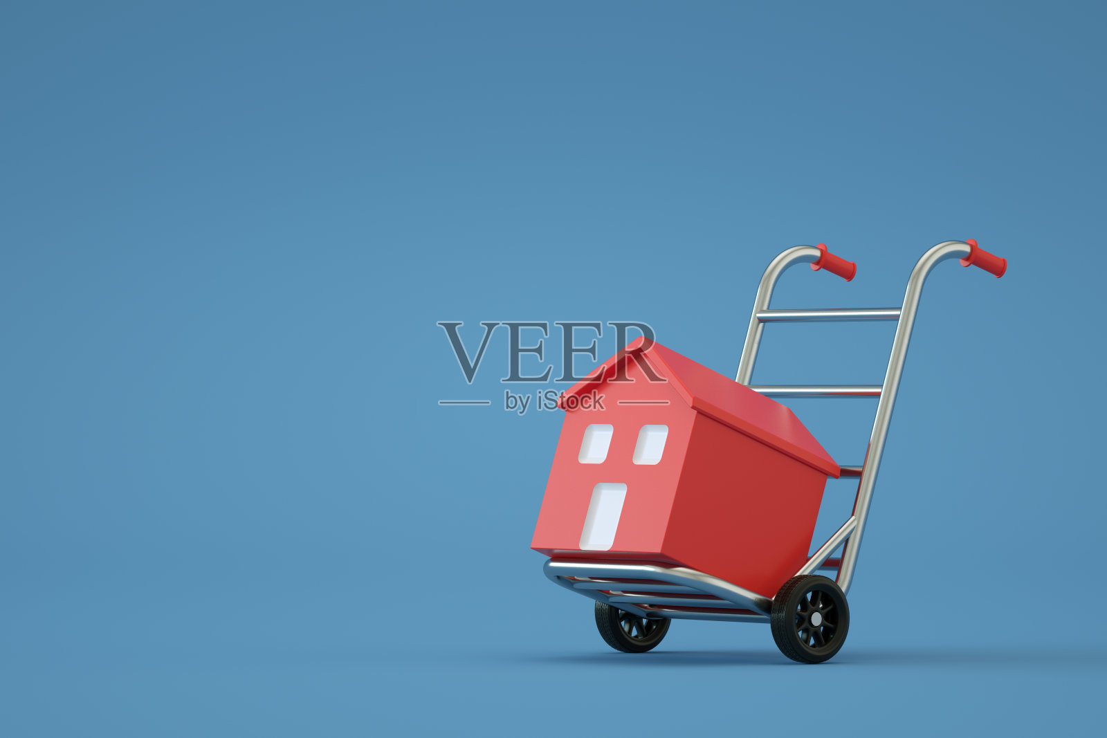 手推车上的房子，搬家的房子，搬迁，蓝色背景照片摄影图片