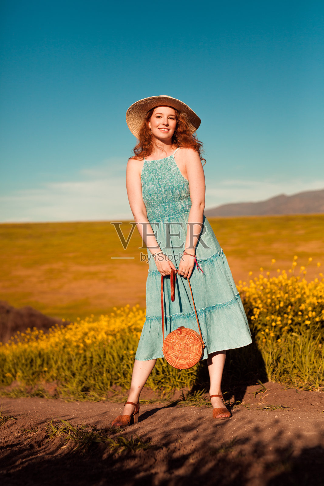 女孩在黄色的花田里照片摄影图片