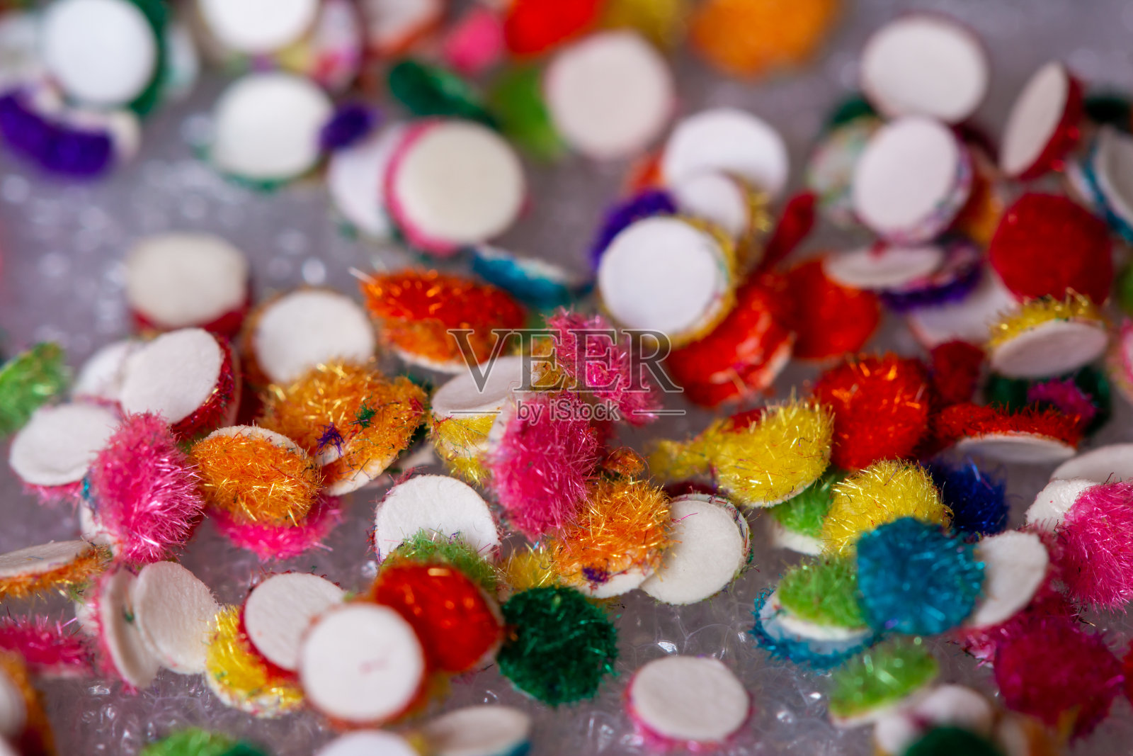 多色宾迪贴纸的近视图，主要由印度女性粘在他们的前额。照片摄影图片