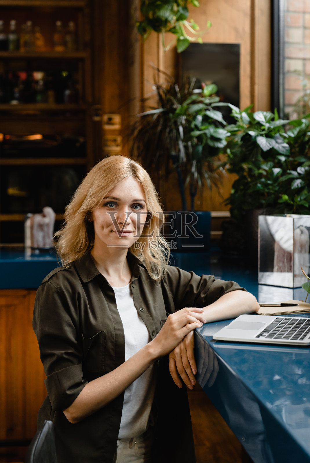 自信的白人年轻学生，女商人，自由职业者，远程工作在笔记本电脑e-learning看着摄像机，在餐厅咖啡馆吃早餐。照片摄影图片