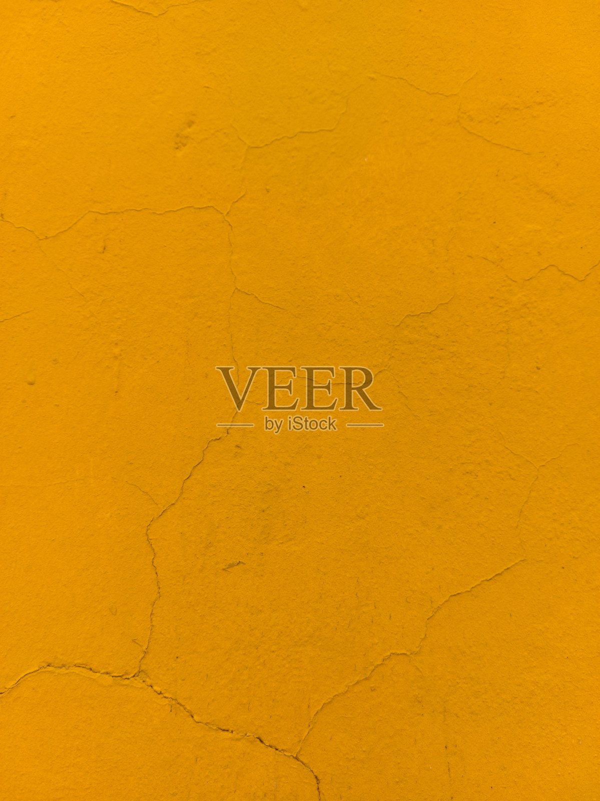 墙面漆成黄色，表面有裂缝照片摄影图片