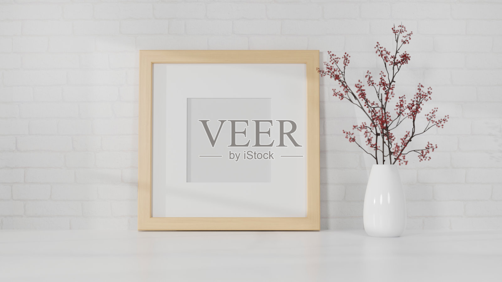 在白色的桌子上画一个简单的木制照片海报框架，白色的墙壁上画一个花瓶。照片摄影图片