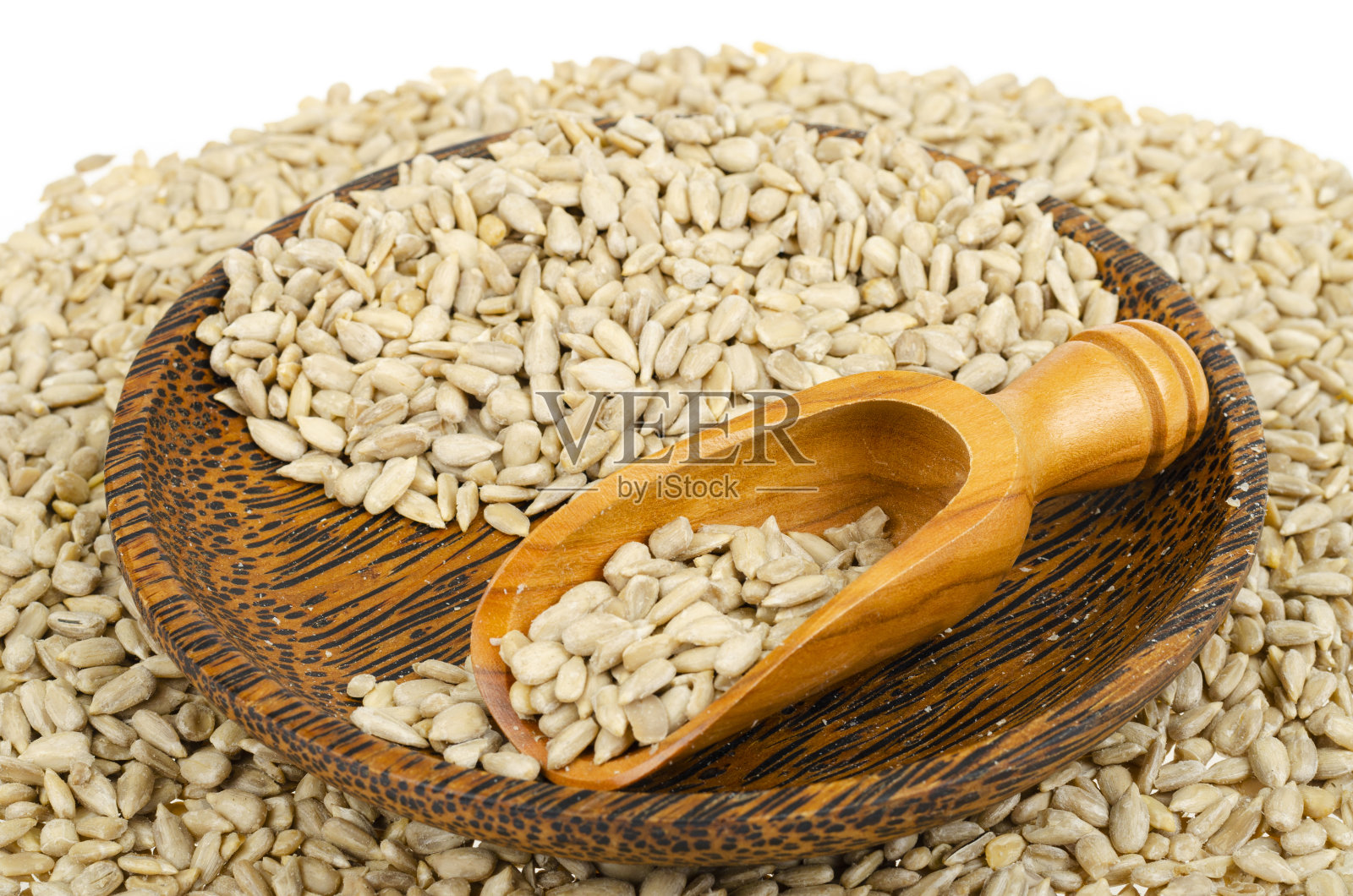 葵花籽去皮，放入碗和勺中照片摄影图片