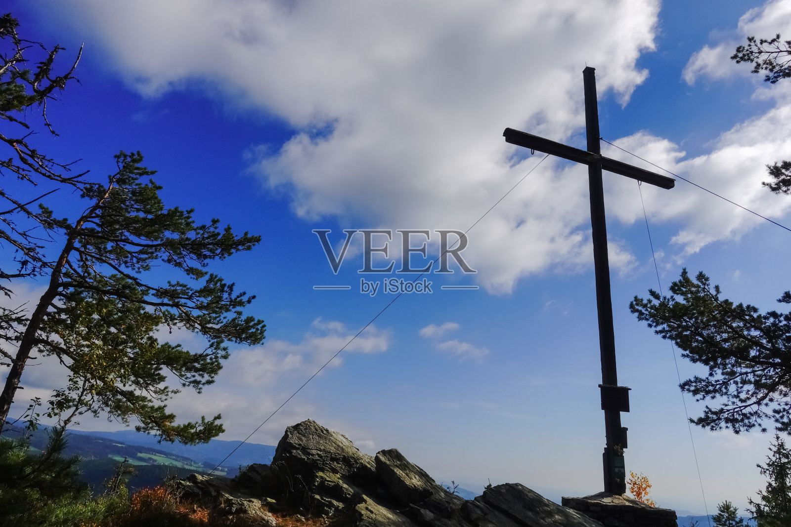 山顶上的树木和岩石之间有白云照片摄影图片