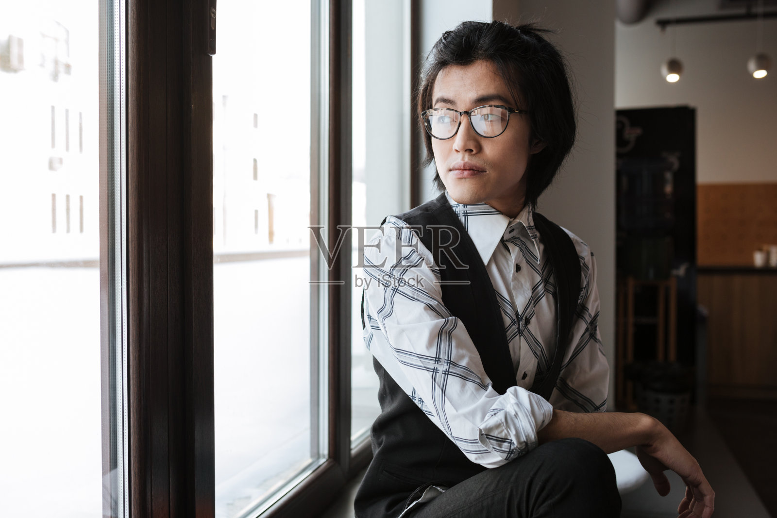 令人惊叹的年轻亚洲人看着一边。共同办公的概念。照片摄影图片