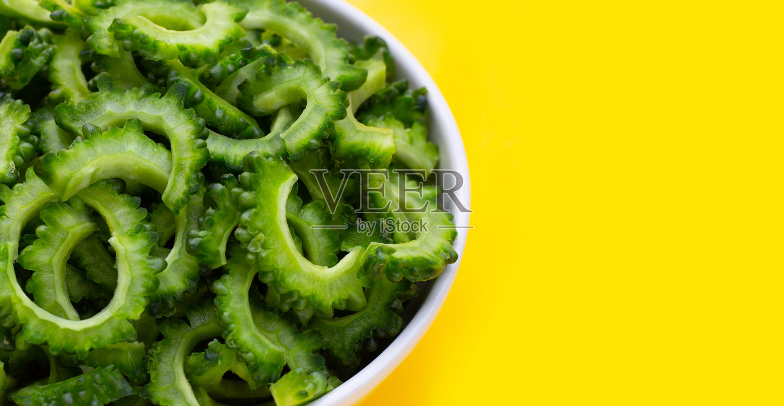 黄底白碗苦瓜片。照片摄影图片