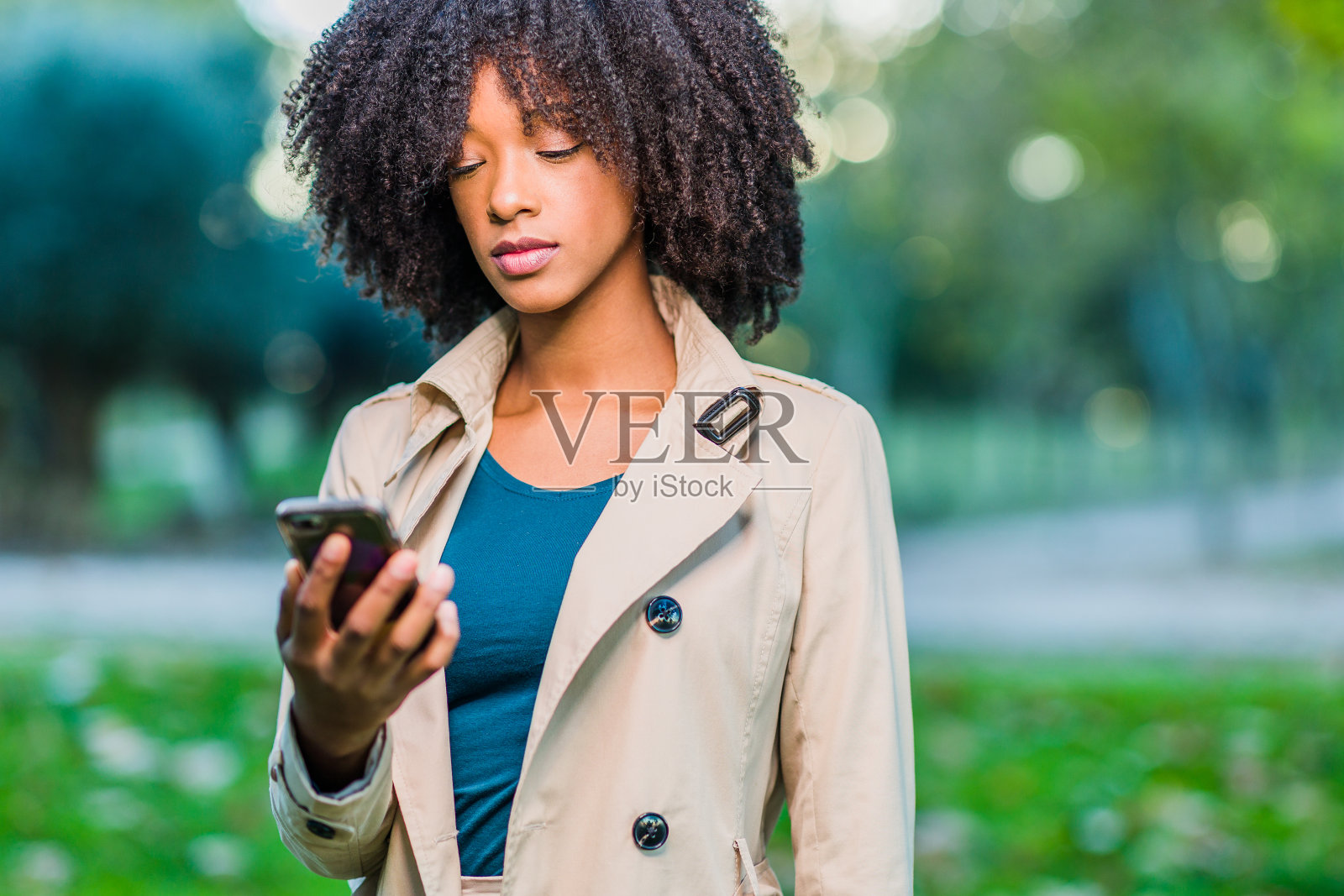 移动技术。拉丁多米尼加共和国女人与非洲式卷发肖像照片摄影图片