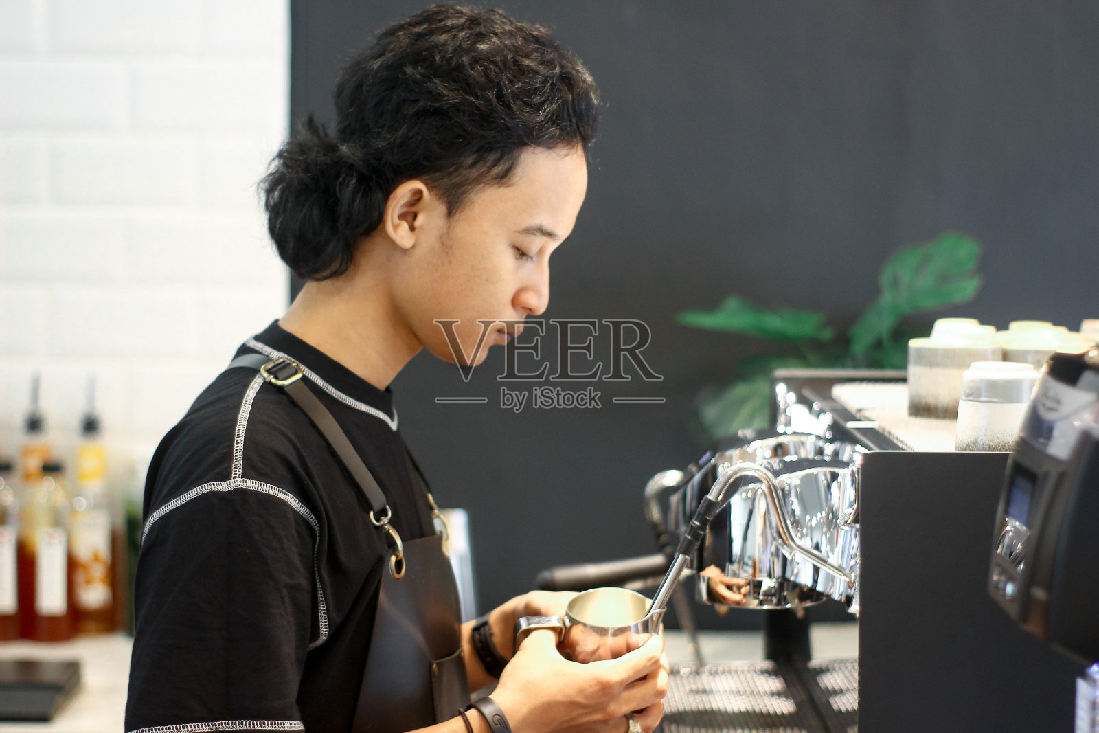 年轻的咖啡师在煮咖啡照片摄影图片