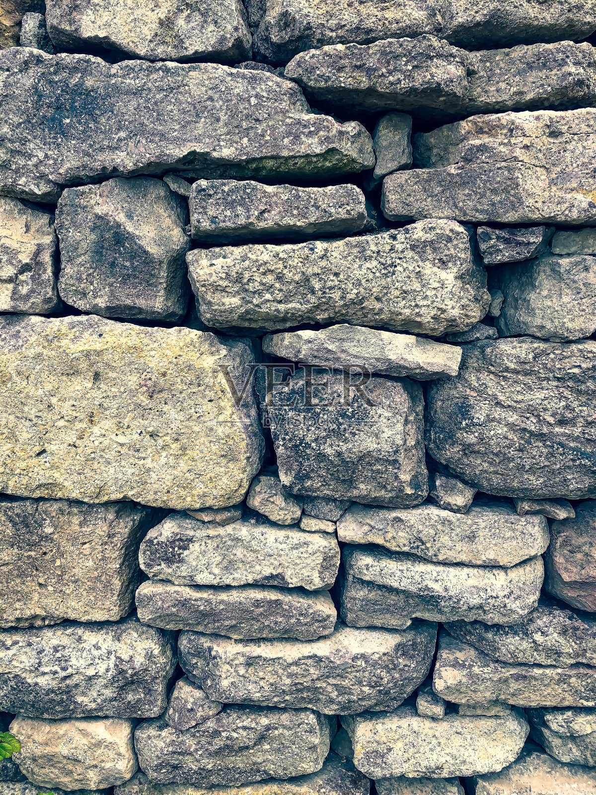 作为纹理或背景的石墙。照片摄影图片