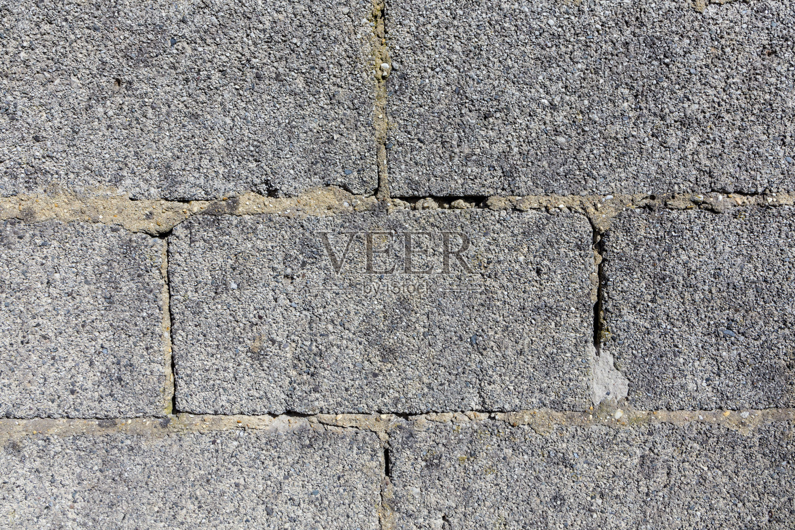 由巨大的灰砖砌成的结构粗糙的旧墙照片摄影图片