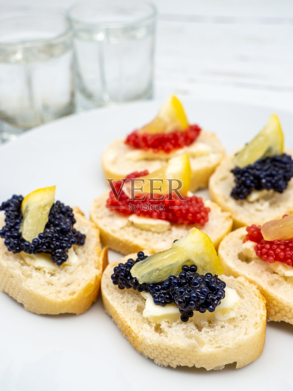 什锦鱼子三明治开胃菜外加几杯伏特加照片摄影图片