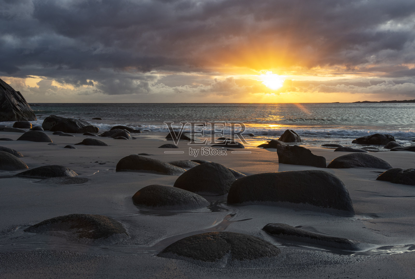 壮观的，五颜六色的日落在北海的海岸。令人惊叹的暴风雨云被夕阳照亮，红色，橙色和粉红色。照片摄影图片
