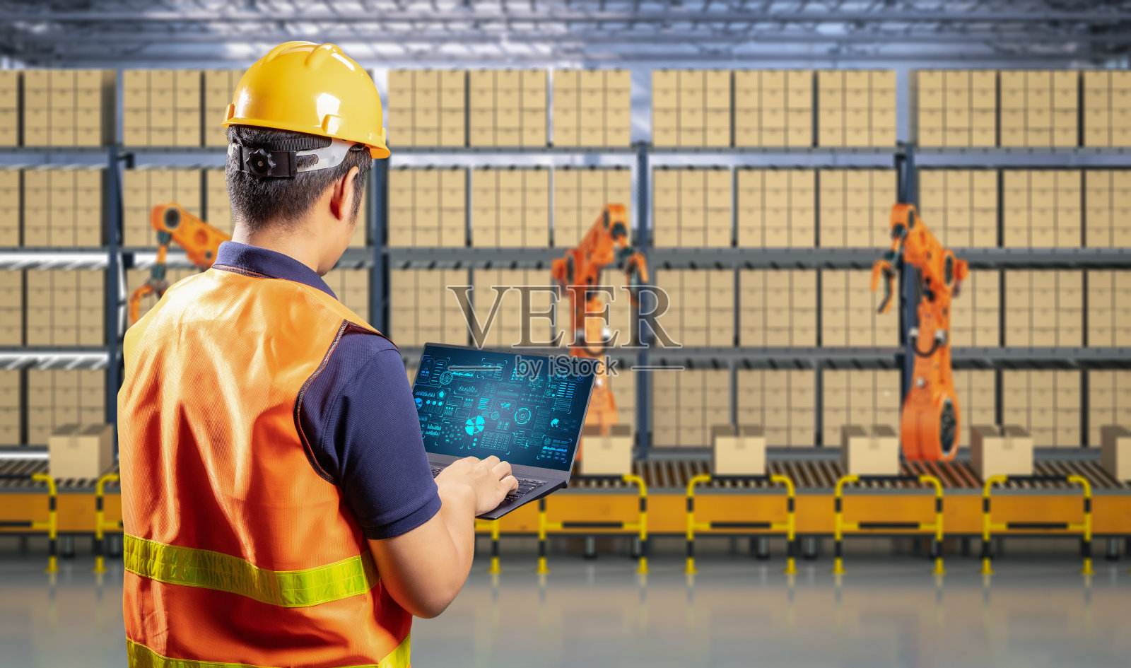 工厂技术员控制自动化机器人照片摄影图片