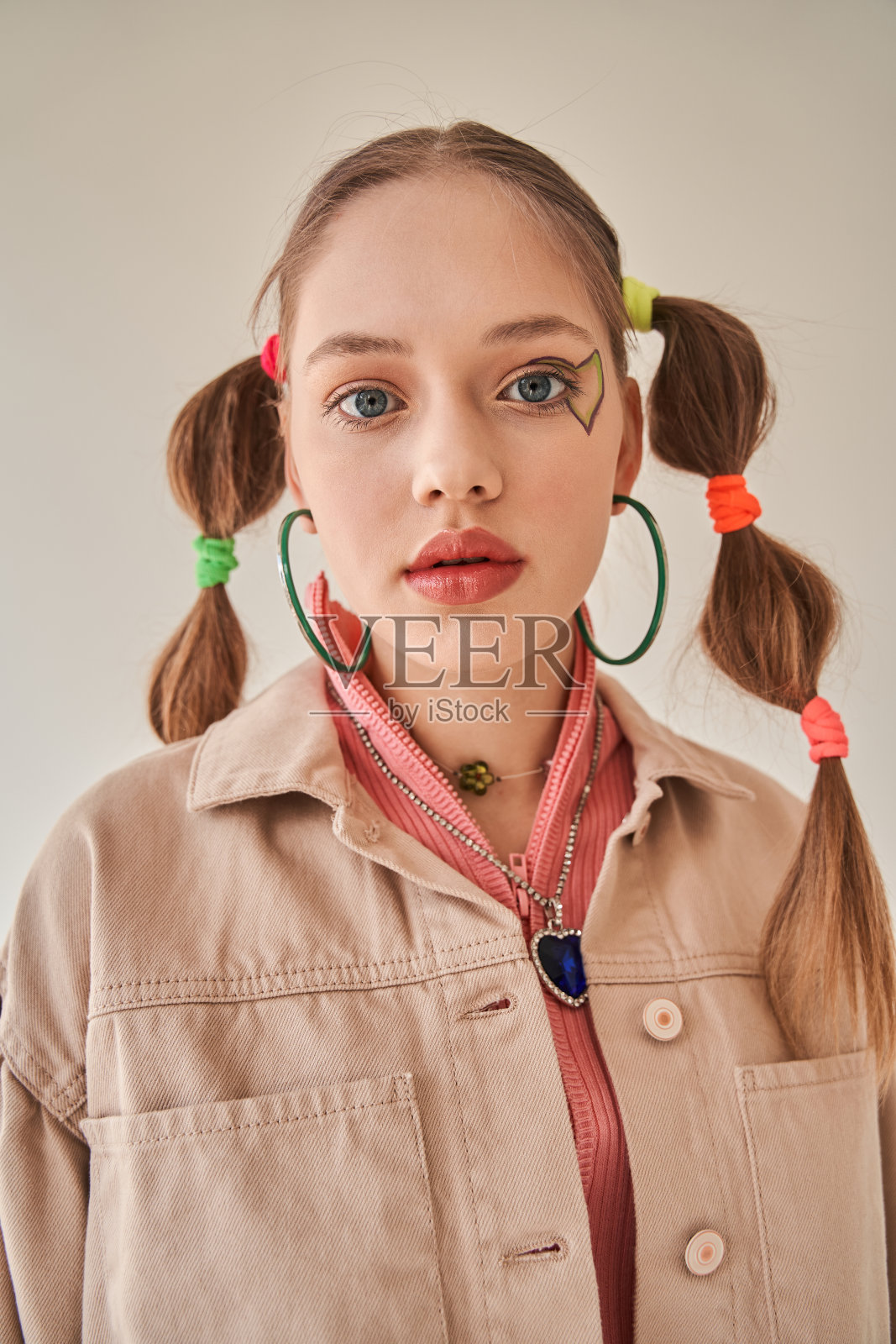 年轻女孩的发型时尚，在工作室摆姿势，看着相机照片摄影图片