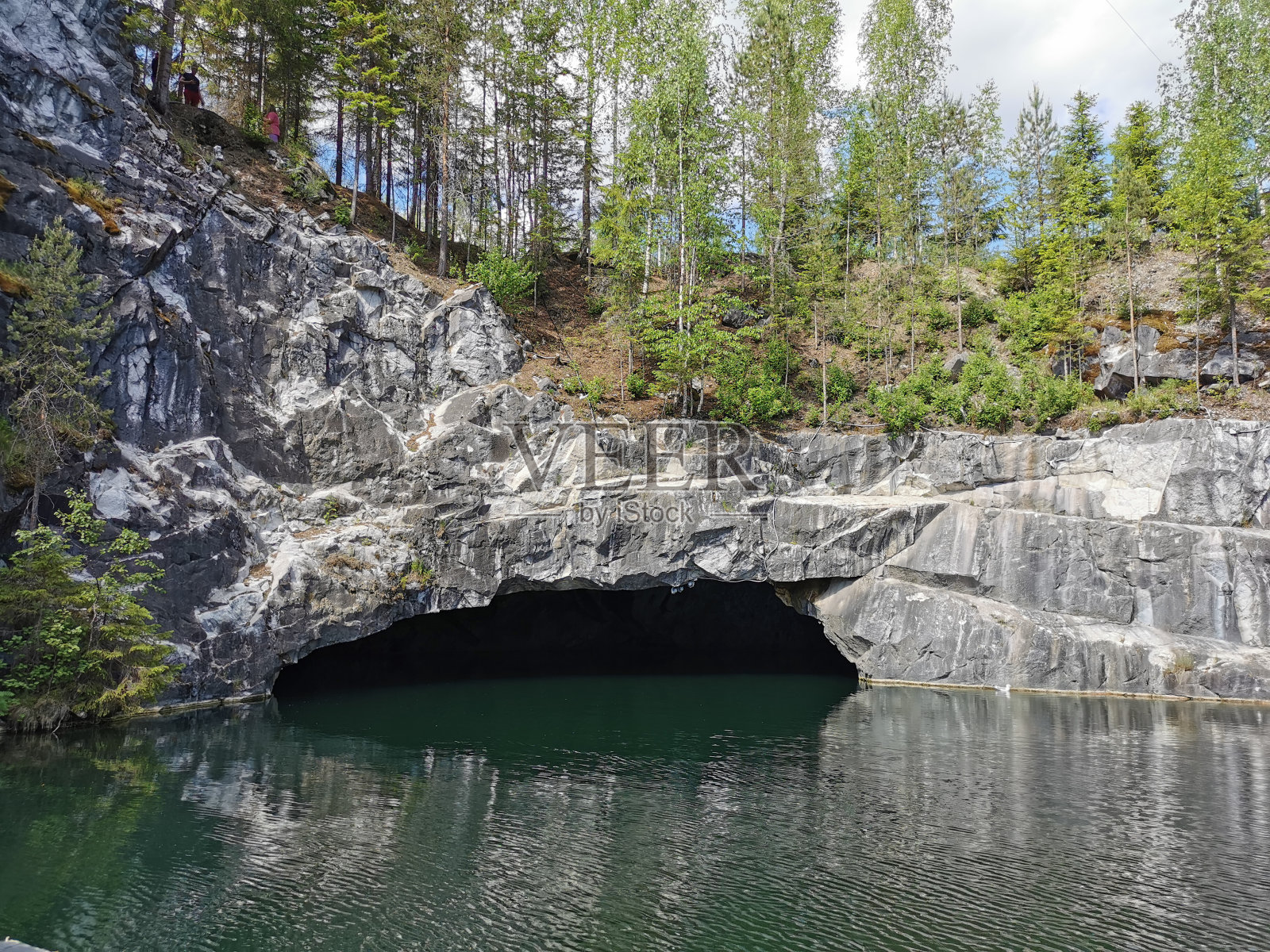 从洞穴的水和被洪水淹没的大理石峡谷的斜坡，树木生长，在山公园Ruskeala。照片摄影图片