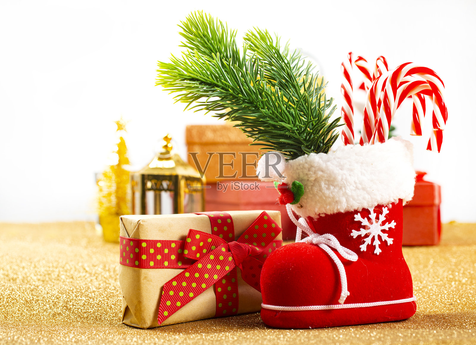 圣诞礼品盒和杉木树枝上的金色背景。带拷贝空间的视图照片摄影图片