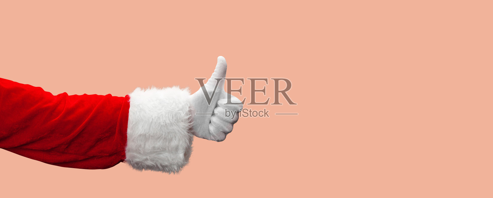 圣诞老人竖起大拇指的手势。照片摄影图片