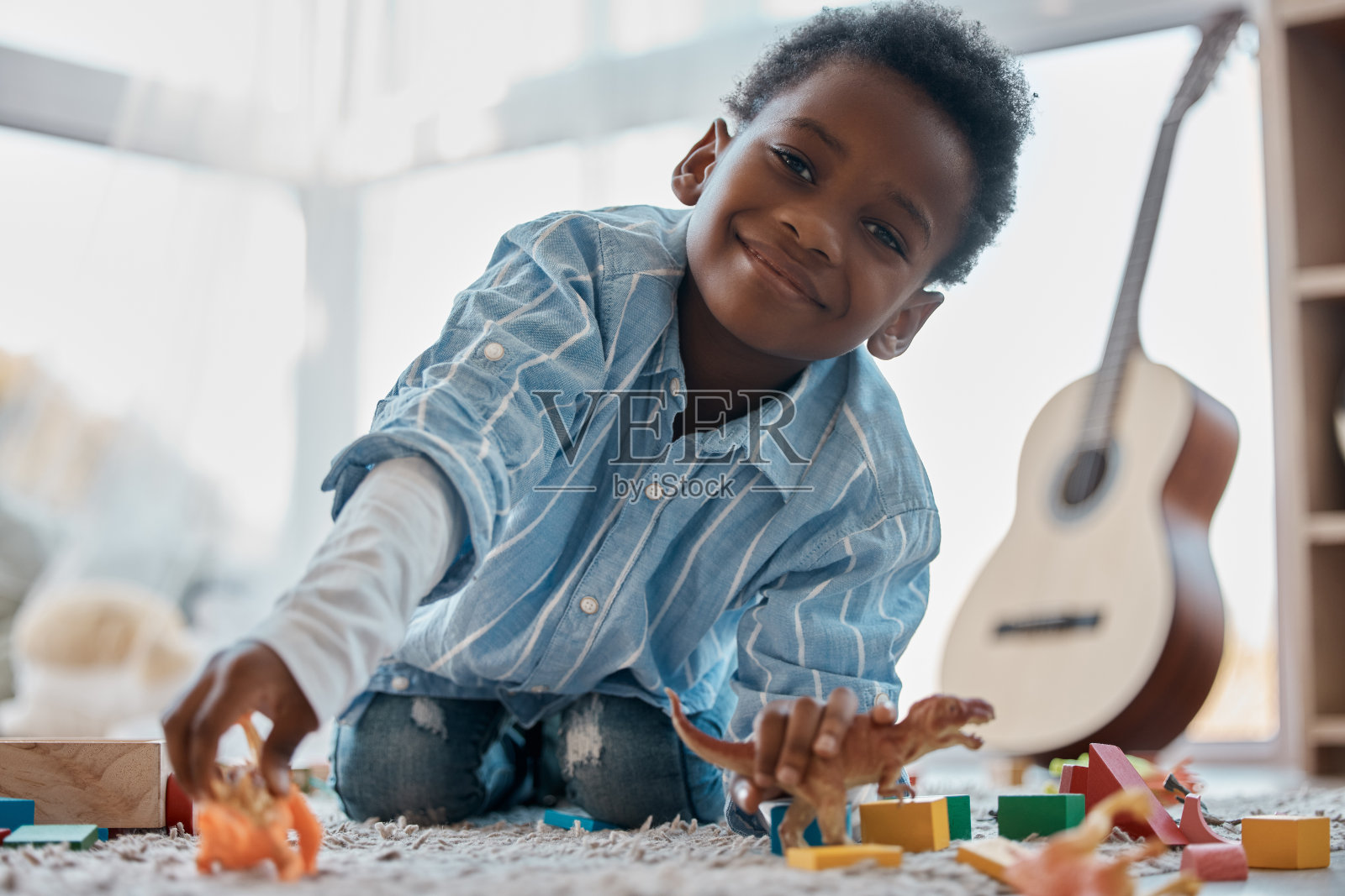 一个可爱的小男孩在他的卧室里玩玩具照片摄影图片