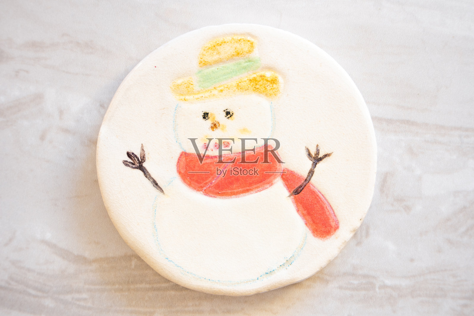 陶瓷圣诞装饰杯垫，白色背景上有雪人的黄色帽子和红围巾插画图片素材