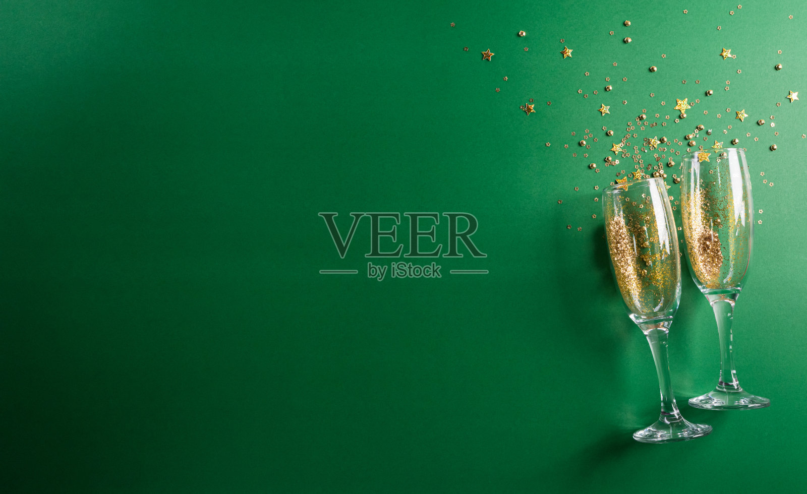 新年快乐庆祝的背景概念从香槟玻璃绿色的背景。照片摄影图片