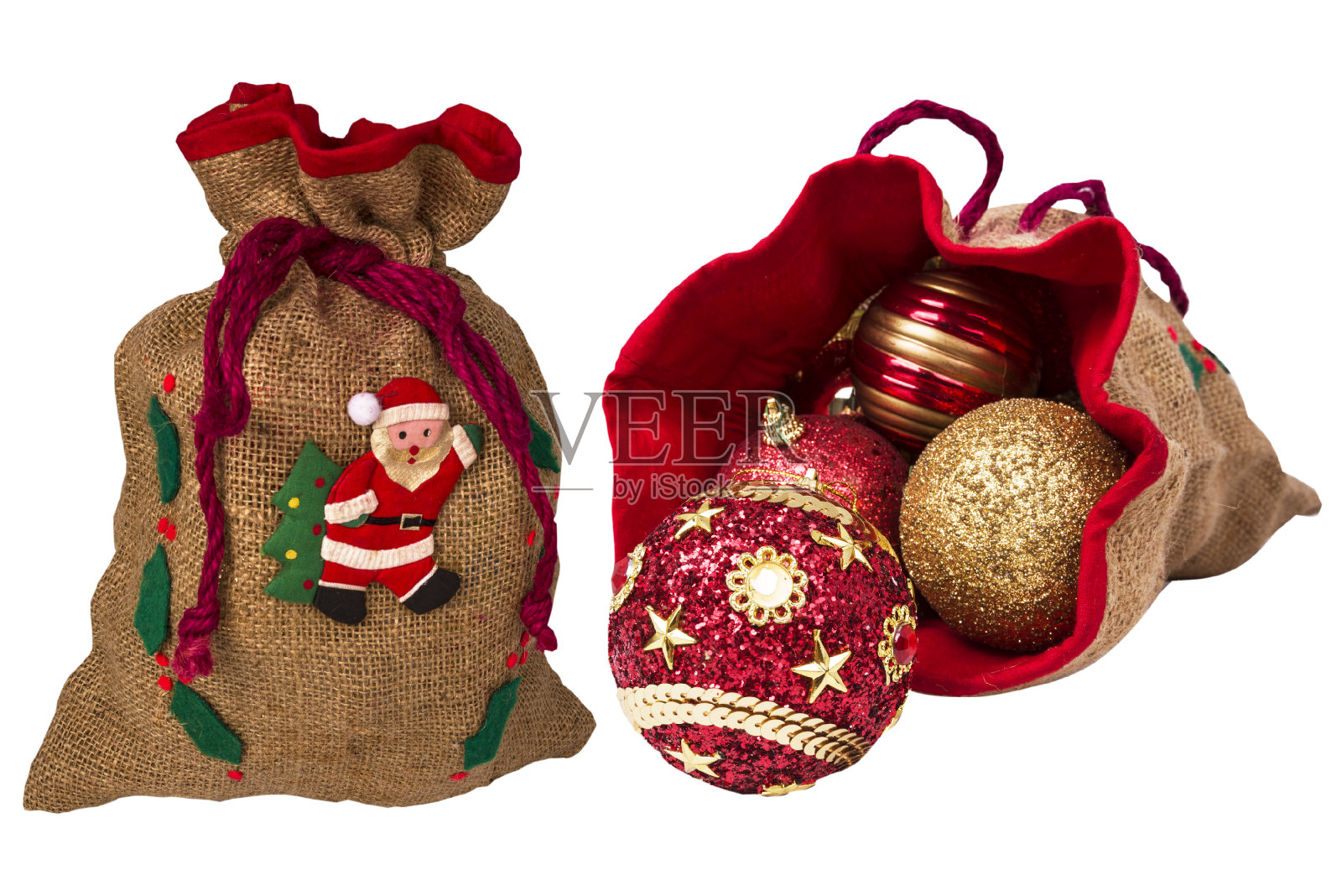 两个白色背景的圣诞袋，里面装着礼物和玩具照片摄影图片